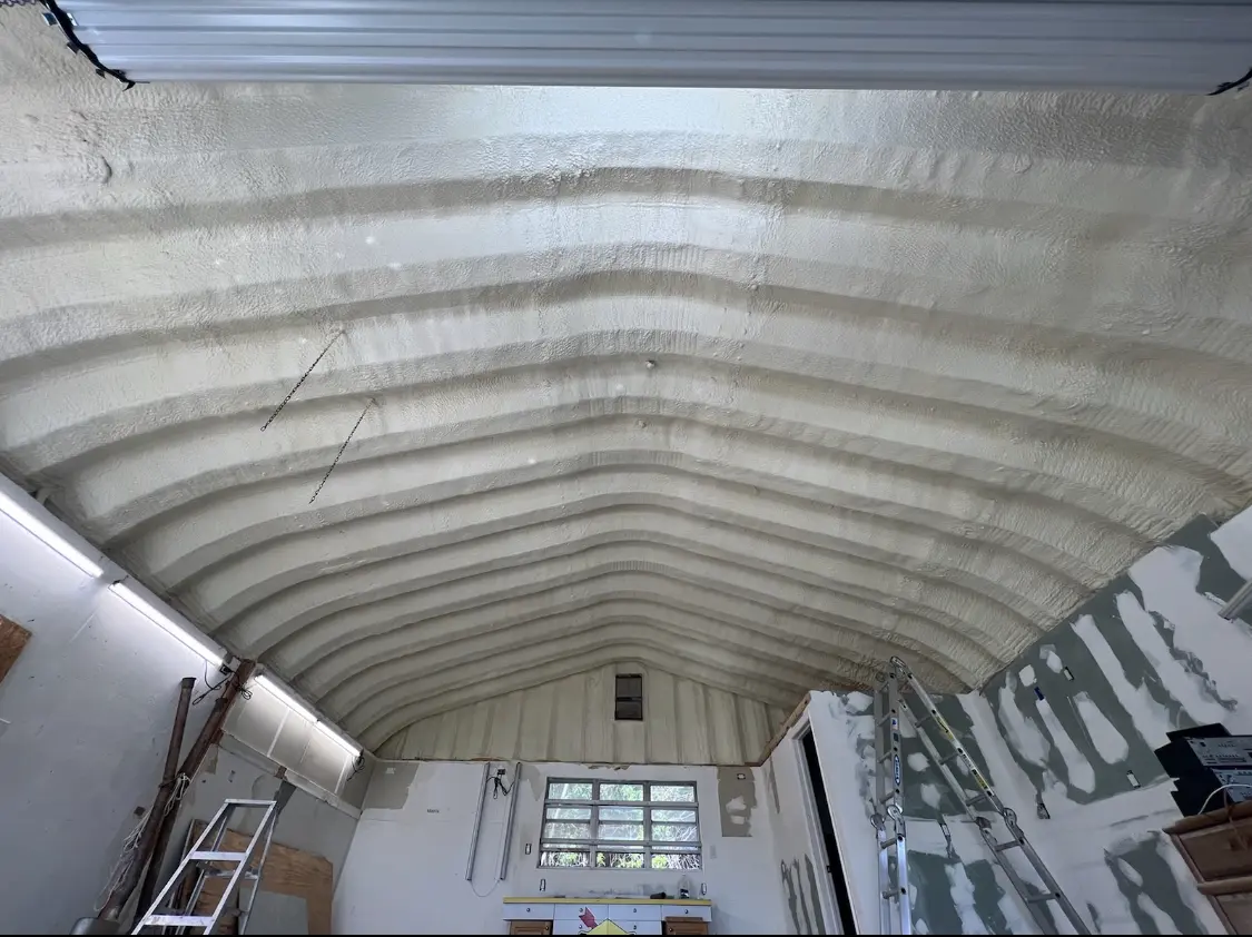 Spray polyurethane foam applied to the underside of a metal roof deck in Wilson